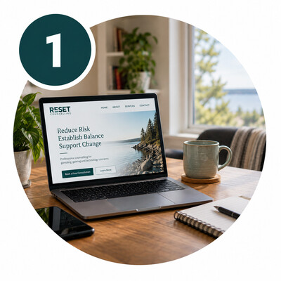 Laptop displaying the RESET Counselling website in a comfortable home workspace.